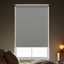 Load image into Gallery viewer, Effective light management with Charcoal Signature room darkening roller shades in a contemporary living space.
