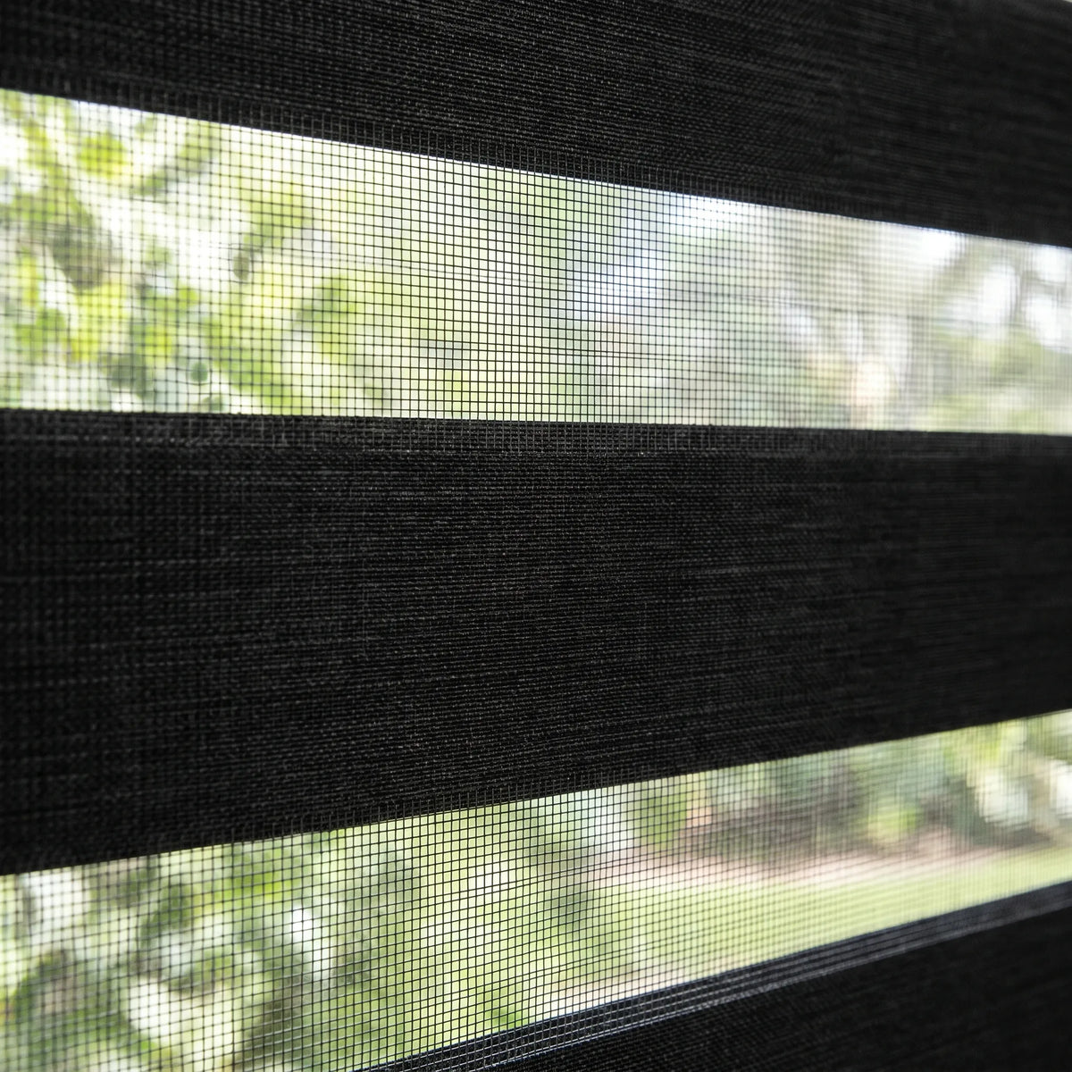 Enhance modern spaces with Zebra Solar Roller Shades, filtering in charcoal-toned light while maintaining privacy and UV protection.