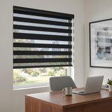 Modern office ambiance with Zebra Solar Roller Shades' charcoal stripes, filtering natural light while maintaining privacy and providing UV protection for a comfortable work environment.