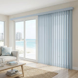 Custom window treatments: Cobalt Classic Curved Pvc Smooth Vertical Blinds shown in a serene living room, perfect for covering sliding glass doors or large windows.