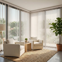 Load image into Gallery viewer, Interior view of a inviting living space styled with Cream (Mammoth Vertical Powder) Signature Pvc Vertical Blinds, offering excellent light control and privacy for large spaces.
