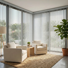 Load image into Gallery viewer, Natural sunlight hits the Cream (Mammoth Vertical Winter) 3 1/2 Inch Signature Pvc Vertical Blinds in this serene living space, managing sunlight and privacy with smooth vertical operation.

