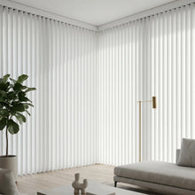 Load image into Gallery viewer, A modern living room featuring Cream (Marie White) Classic Curved Pvc Smooth Vertical Blinds, delivering sleek functionality and room-darkening capabilities.

