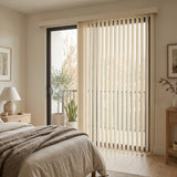 Signature Collection Fabric Vertical Blinds expertly filter natural light in this serene bedroom, where beige tones and cream-colored shades harmonize perfectly.