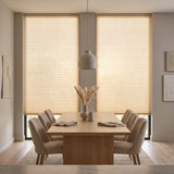 Simplistic Cordless Pleated Shades in Cream effortlessly filter natural light, complementing beige curtains and modern minimalism in this serene dining room.