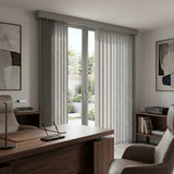 Signature Collection Fabric Vertical Blinds in Creamy Gray enhance this serene study's ambiance with soft, filtered light and a stylish gray pattern.