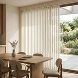 Showcasing Creamy (Light Beige) Classic Curved Pvc Smooth Vertical Blinds in a inviting living space, offering excellent light control and privacy for large spaces.