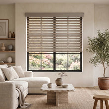 Load image into Gallery viewer, Softly filtered sunlight pours through wooden windows, perfectly harmonized by the Hardwood Cordless Horizontal Blinds' creamy white and brown slats.
