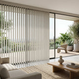 Natural sunlight hits the Creamy 3 1/2 Inch S Shape Pvc Vertical Blinds in a cozy retreat, providing elegant, wave-like window coverage.