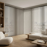 A look at Creamy 3 1/2 Inch Signature Pvc Vertical Blinds inside a inviting living room, delivering sleek functionality and room-darkening capabilities.