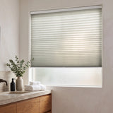 Simplistic Cordless Pleated Shades in Creamy white adorn this modern bathroom, perfectly balancing the wooden vanity's warm tones and sleek sink area.