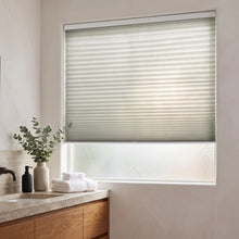 Load image into Gallery viewer, Simplistic Cordless Pleated Shades in Creamy white adorn this modern bathroom, perfectly balancing the wooden vanity's warm tones and sleek sink area.
