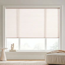 Load image into Gallery viewer, A look at Creamy White (Alabaster) 7 16 Inch Double Cell Light Filtering Shades inside a warm living space, softening harsh rays while keeping the space bright.
