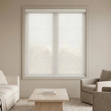 Load image into Gallery viewer, Interior view of a warm living space styled with Creamy White (White Dove) 9 16 Classic Single Cell Light Filtering Cordless Shades, beautifully diffusing natural sunlight.
