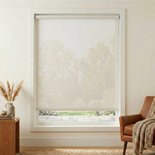 Load image into Gallery viewer, Premier 5% Solar Screen Roller Shade filters white light, blocking UV rays while allowing natural illumination into this inviting creamy white themed room.

