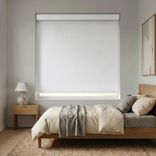 Load image into Gallery viewer, Modern Fabric Blackout Roller Shades in creamy white add sophistication and light blocking functionality to this minimalist bedroom, perfect for a restful retreat.
