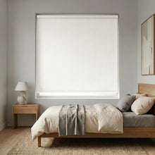 Load image into Gallery viewer, Modern Fabric Blackout Roller Shades in Creamy White add a touch of elegance to this serene modern bedroom, blocking out light and promoting a restful ambiance.

