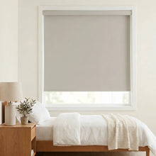Load image into Gallery viewer, Classic Fabric Blackout Roller Shades seamlessly complement creamy white walls in this modern bedroom, filtering natural light with precision and simplicity.
