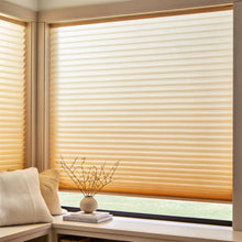 Load image into Gallery viewer, Custom window treatments: Creamy White 9 16 Classic Single Cell Light Filtering Cordless Shades shown in a modern bedroom, reducing screen glare while welcoming natural sunshine.
