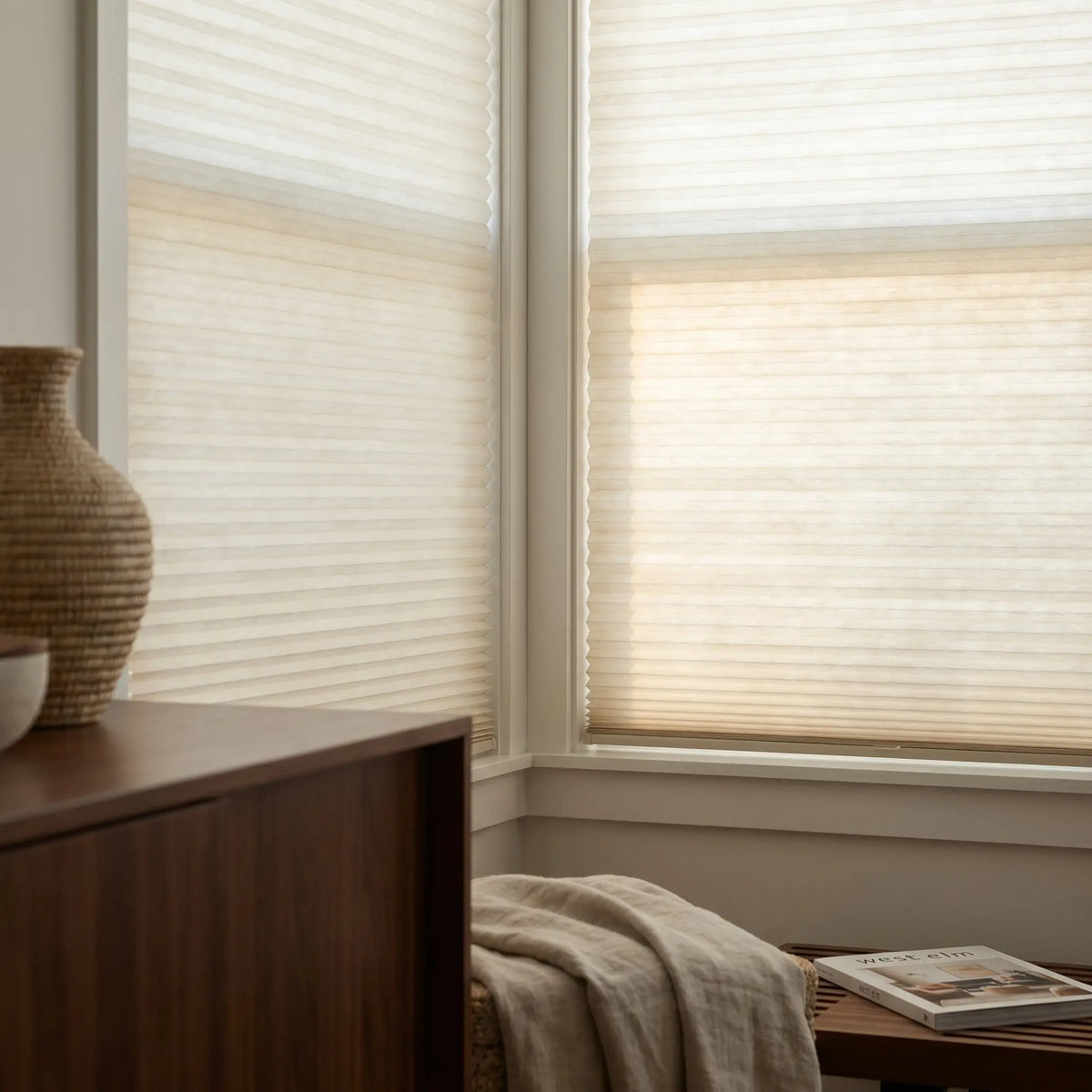Showcasing Creamy White (Snow White) 7 16 Inch Double Cell Light Filtering Shades in a modern living space, softening harsh rays while keeping the space bright.