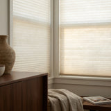 Showcasing Creamy White (Snow White) 7 16 Inch Double Cell Light Filtering Shades in a modern living space, softening harsh rays while keeping the space bright.