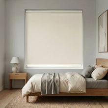Load image into Gallery viewer, Modern Fabric Blackout Roller Shades in Creamy White elevate this serene bedroom sanctuary with seamless light blocking and timeless design.

