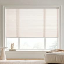 Load image into Gallery viewer, This inviting living room is enhanced by Creamy White (Winter White) 7 16 Inch Double Cell Light Filtering Shades, delivering elegant light diffusion and daytime privacy.
