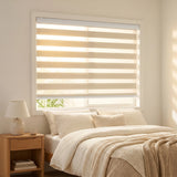 Zebra Light Filtering Roller Shades add warmth to this serene bedroom with creamy white accents and soft, filtered light.