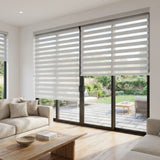 Zebra Solar Roller Shades in Creamy White enhance natural light while providing UV protection and stylish ambiance for this cozy living room.