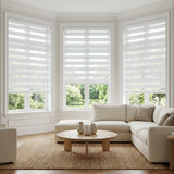 Modern living room ambiance enhanced by Zebra Solar Roller Shades' creamy white hue, filtering natural light while providing UV protection.