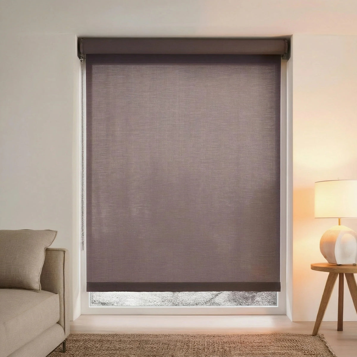 Close-up of dark brown Chocolate light filtering roller shades installed in a cozy bedroom with warm lighting.