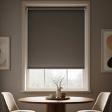 Economy Basic Vinyl Blackout Roller Shades in a doe hue bring calm elegance to this dining room, blocking out light and creating a serene atmosphere.
