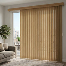 Load image into Gallery viewer, Woodtone Faux Wood PVC Vertical Blinds in Earth tone harmonize with urban cityscape views, while a gray couch and potted plant create a serene ambiance.
