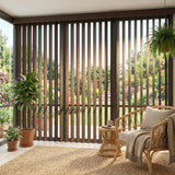 A look at Earth (Turnberry Washed Brown) S Shape Pvc Vertical Blinds inside a cozy living room, offering excellent light control and privacy for large sliding doors.