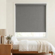 Load image into Gallery viewer, Classic Fabric Blackout Roller Shades in Gray perfectly complement this serene bedroom, providing light blocking and a peaceful ambiance.
