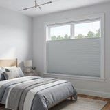 Gray Atlantic-Frost Signature Blackout Double Cellular Shade on a bedroom window beside a wood nightstand