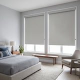 Gray Classic Blackout Vinyl Roller Shades on twin bedroom windows in a cool neutral palette