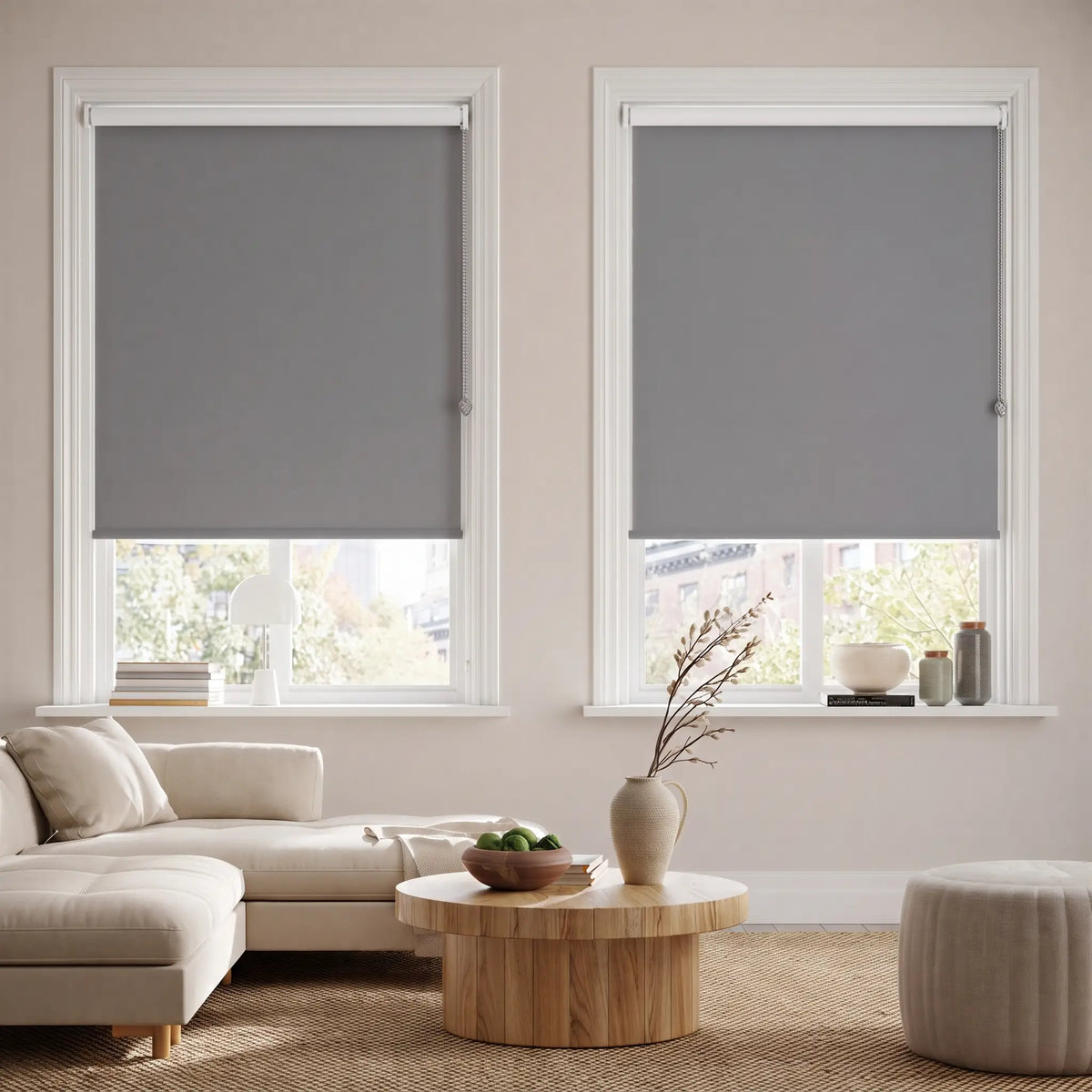 Classic Blackout Vinyl Roller Shades in a modern living room, evoking a cozy atmosphere with gray tones and dimmed light.