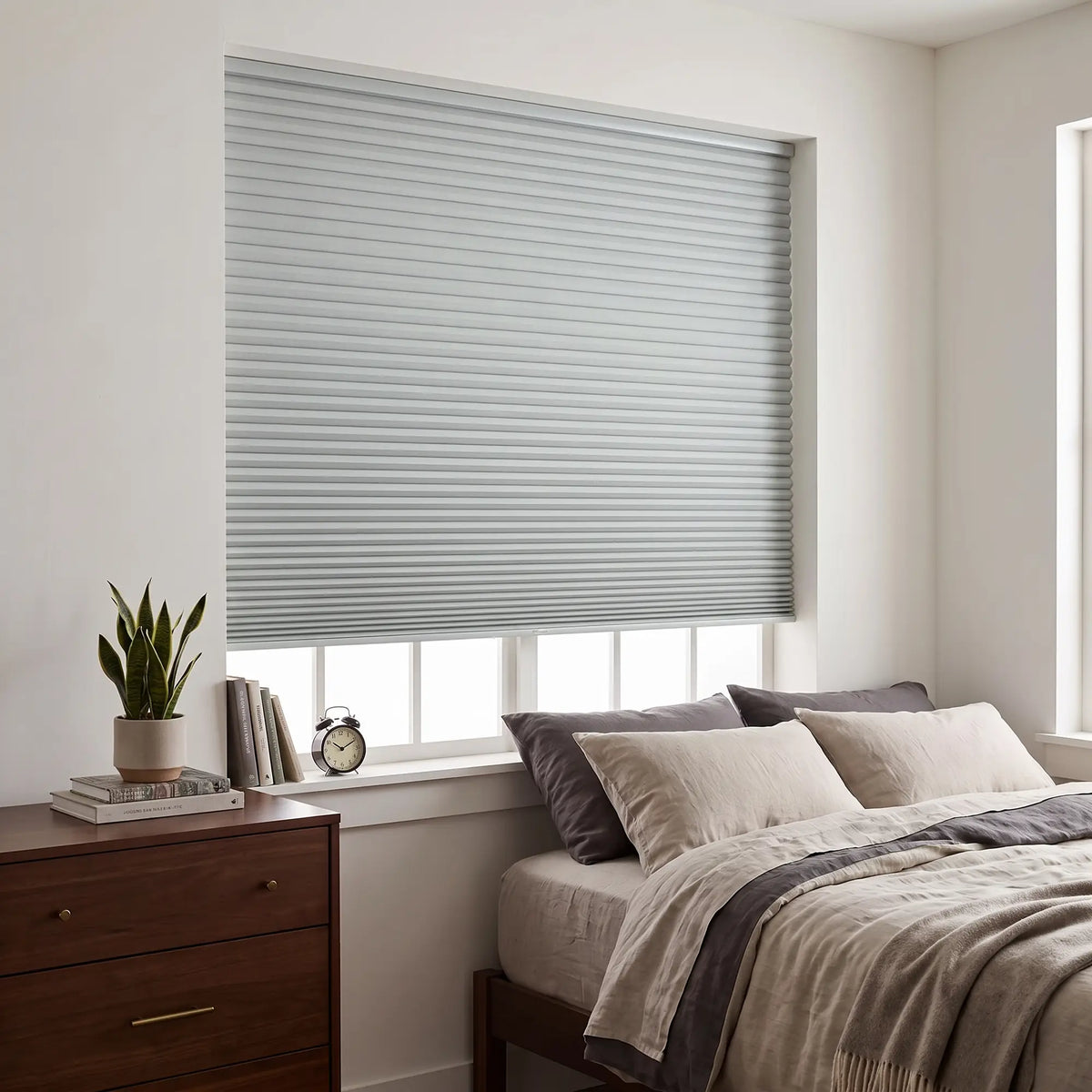 Gray Elegant-Dove Signature Blackout Double Cellular Shade on a bedroom window beside a wood nightstand