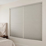 Gray Elegant-Dove Signature Blackout Single Cellular Shade on a bedroom window beside a mid-century nightstand