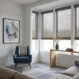 Greyhound Natural Bamboo Shades in charcoal gray on a modern living room bay window
