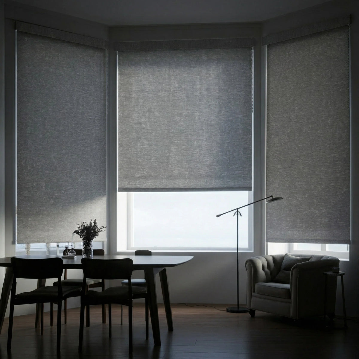 Gray Jerusalem Grey Luxe room darkening shades installed in a contemporary dining room bay window, providing privacy.