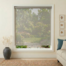 Load image into Gallery viewer, Premier 14% Solar Screen Roller Shade in gray, softly filtering the living room's natural light, creating a serene ambiance with precise temperature control.
