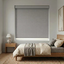 Load image into Gallery viewer, Modern Fabric Blackout Roller Shades in gray elegantly complement this calming bedroom's neutral atmosphere, filtering natural light and ensuring restful sleep.
