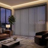 Gray 3 1/2 Inch S Shape Pvc Vertical Blinds providing a structured touch to a cozy living room, delivering a drapery-like aesthetic with easy-to-clean functionality.