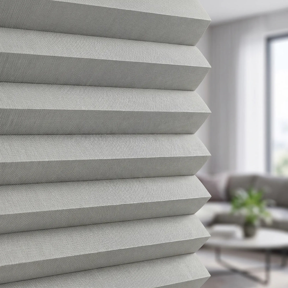 Simplistic Cordless Pleated Shades bring a touch of elegance to this serene space, where gray tones and natural light harmonize beautifully amidst white walls and subtle decor.