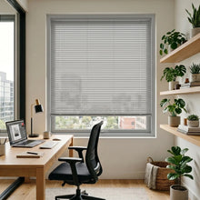 Load image into Gallery viewer, Gray (Smokey Grey) Classic Cordless 6g Aluminum Mini Blinds installed in a cozy reading, combining practical glare reduction with a minimalist design.
