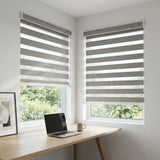 Zebra Solar Roller Shades in Gray elegantly filter natural light while providing UV protection and a comfortable atmosphere for working or relaxing.