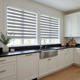 Elevate your modern kitchen with Zebra Solar Roller Shades in sleek Gray, offering UV protection and seamless window treatments.