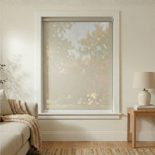 Load image into Gallery viewer, Main front view of a Grey Sandstone Signature solar roller shade in a sun-drenched living room.
